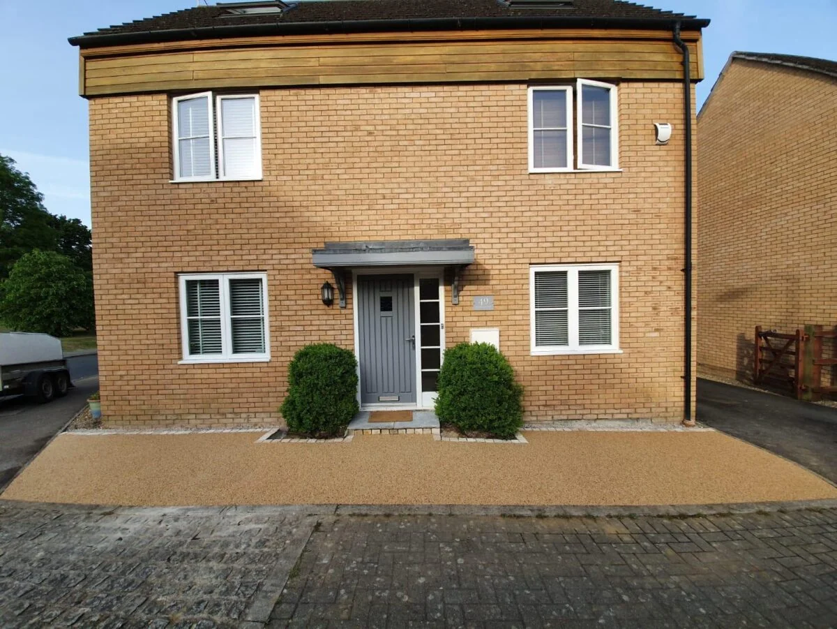 Resin bound driveway installed by WV Landscapes outside a brick home